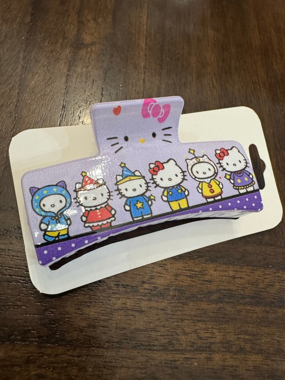 large Hello Kitty purple hair clip claw with Hello Kitty characters in costumes